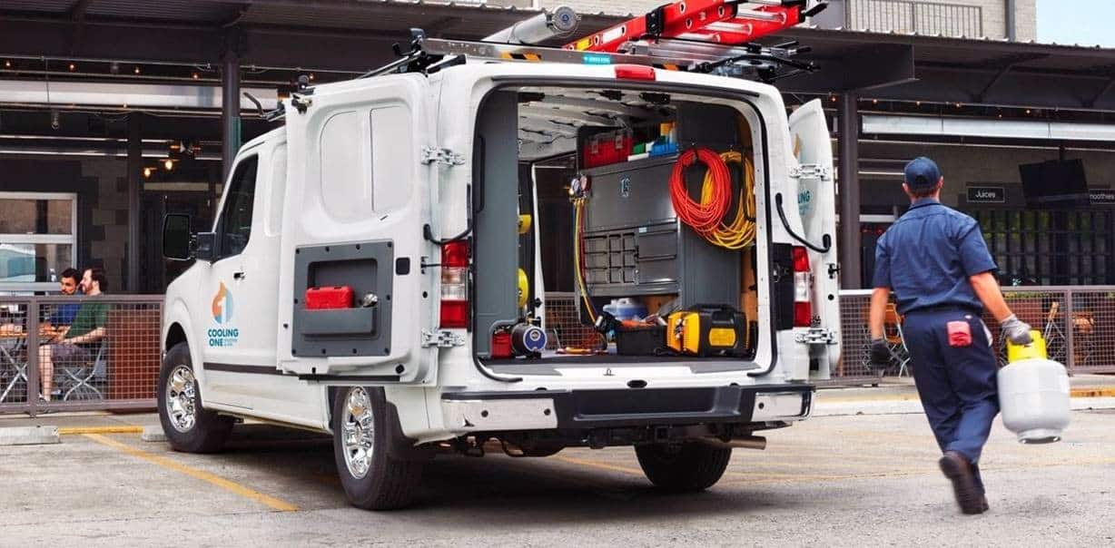 Commercial HVAC service van with technician